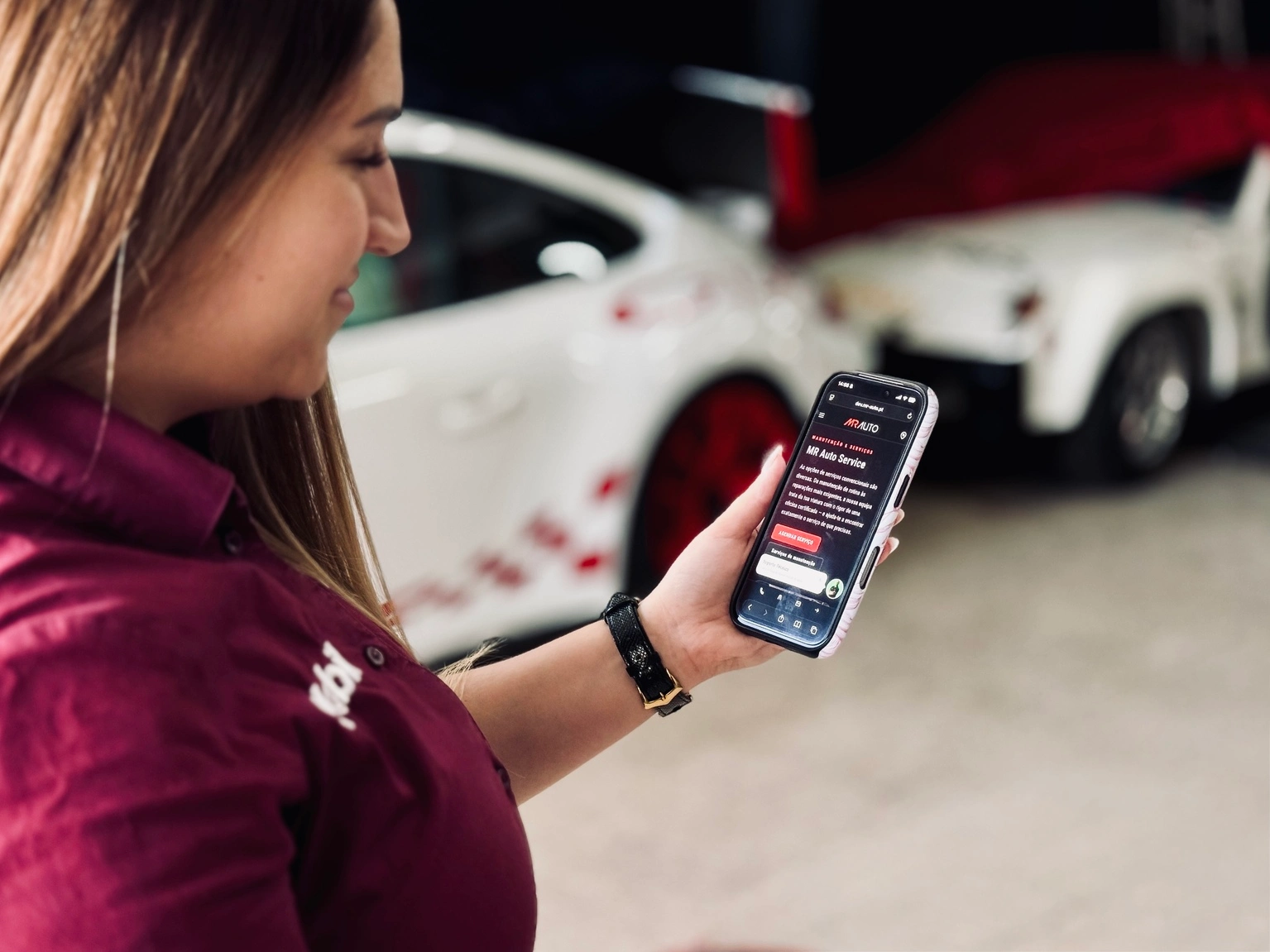 Cliente a consultar a área My MR Auto no telemóvel junto à sua viatura